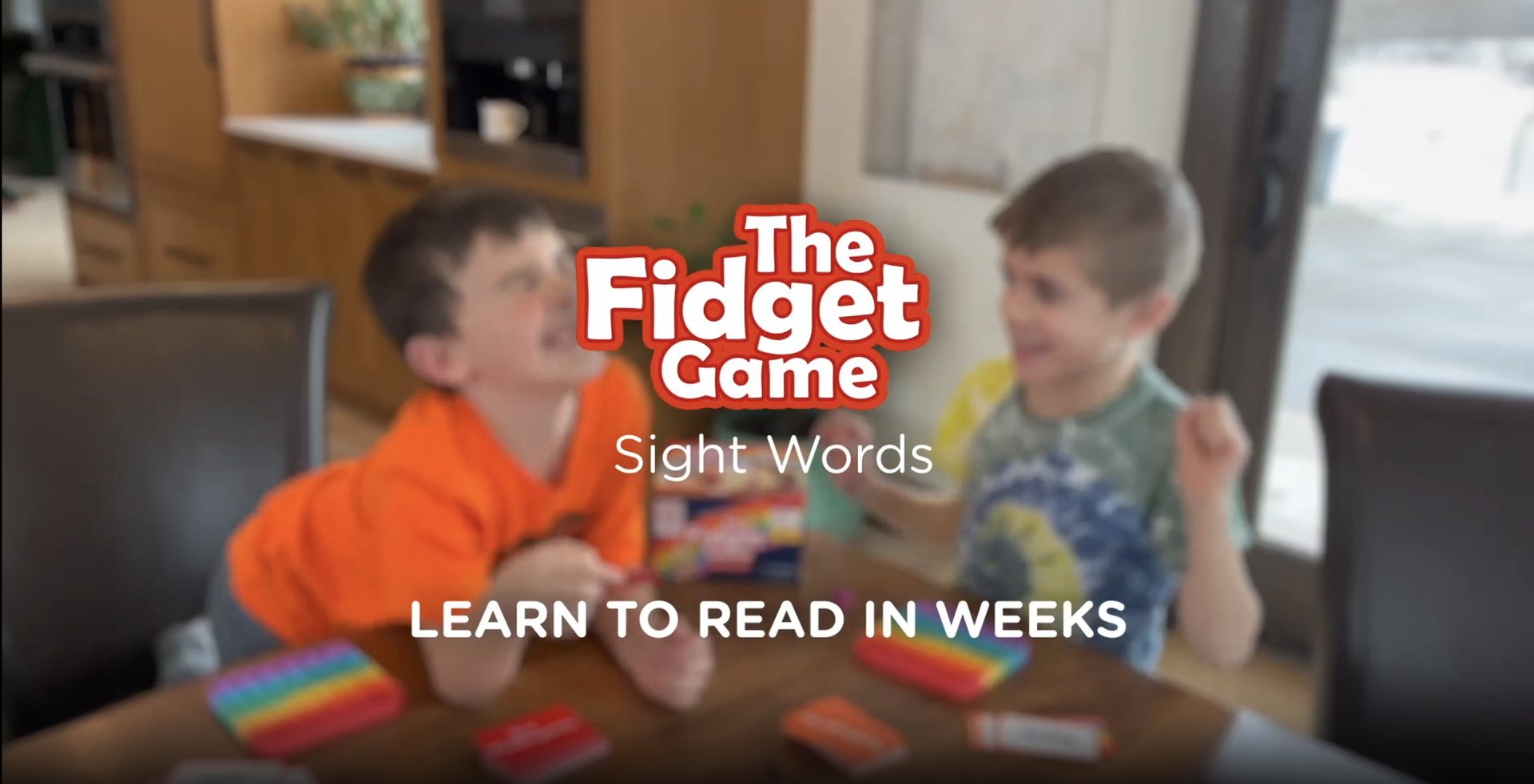 Promo video still: two kids playing The Fidget Game, 'Learn to read in weeks'